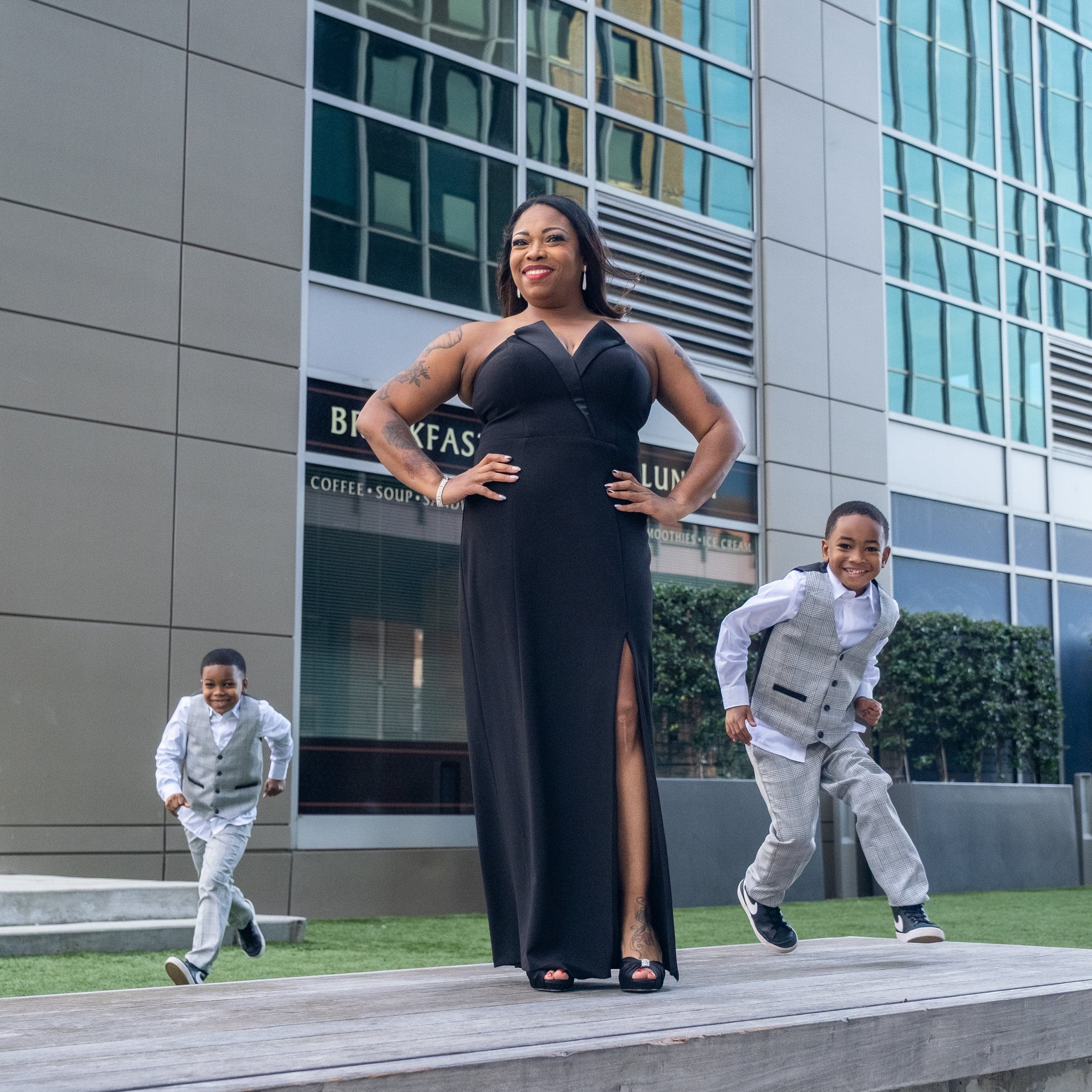 Mother and sons running joyfully downtown