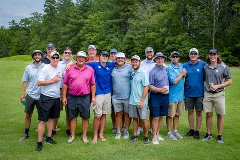 Group portrait of golfers on the green