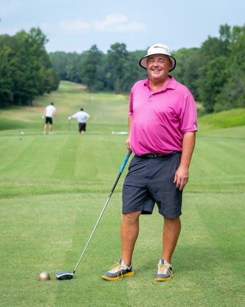 Golfer posing at the tee box