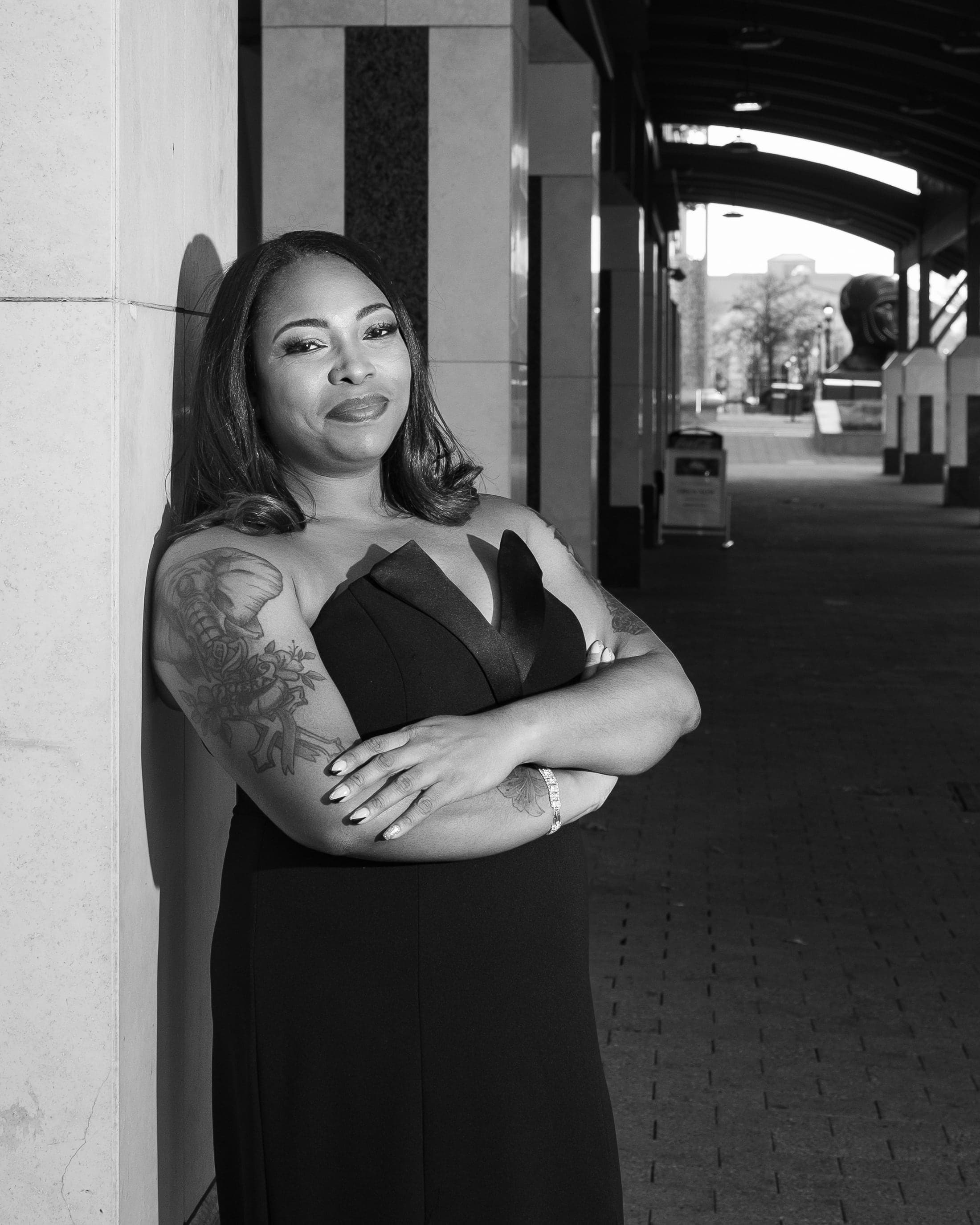Black and white portrait beneath a colonnade