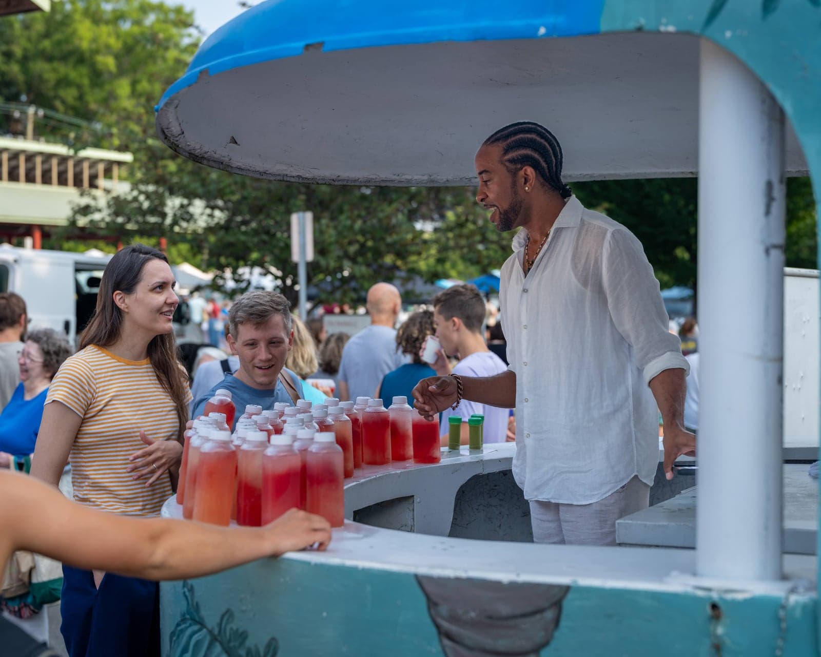 Watermelon juice vendor serving a customer