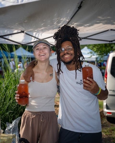 Friends sharing a laugh at a local market stall