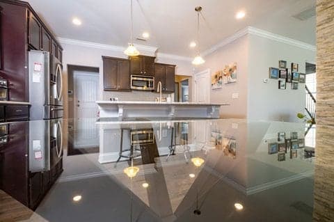 Modern kitchen interior with dark cabinetry and pendant lighting